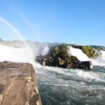 A picture of willamette falls with a rainbow from a Portland kayaking trip