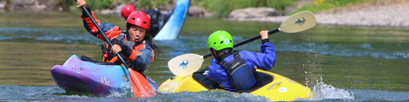 Kids in white water kayaks