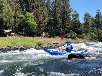 Children paddling in white water inflatable kayaks on the Santiam River