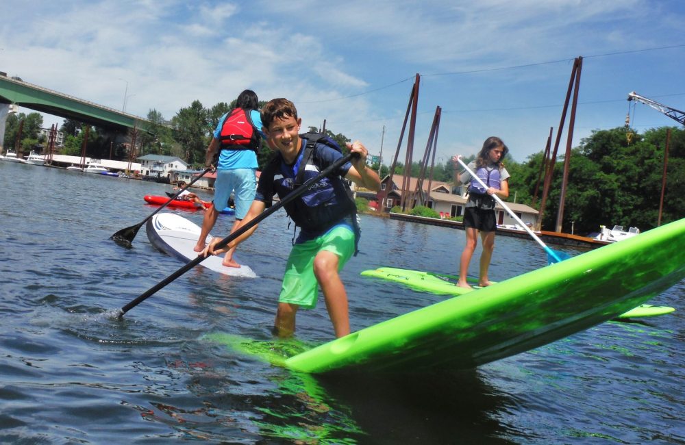 Summer Camp kids paddle boarding on the Willamette River