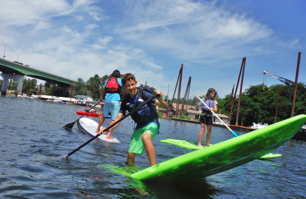 Summer Camp kids paddle boarding on the Willamette River