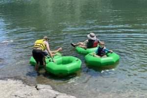 A family getting into their inner tubes